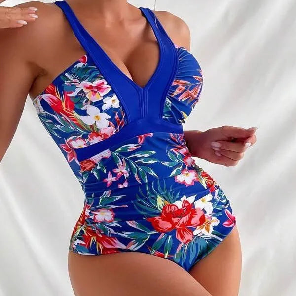 Women's floral print backless one-piece swimsuit on a model, showing the tight fit and stretchy fabric.