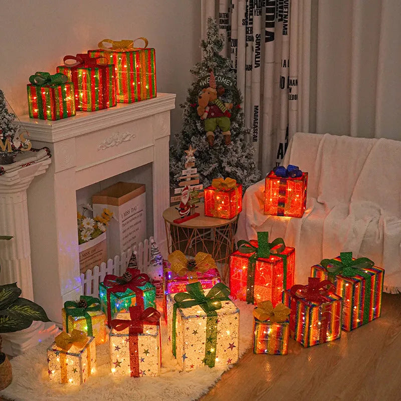 Set of three lighted Christmas gift box decorations with bows and LED lights for holiday displays