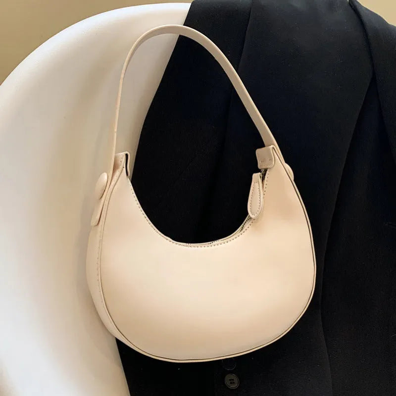 Retro dumpling-shaped women's shoulder bag in PU leather with a front pocket.
