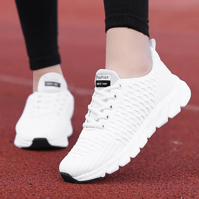 Women's running shoes with fly weave upper in black, pink or white on wear-resistant outsole.