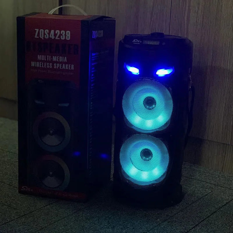Black portable Bluetooth speaker with dual horn design and MP3 card slot on desktop