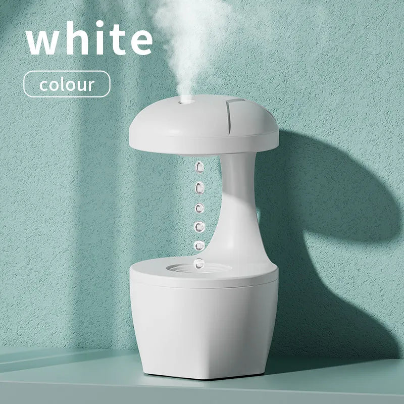 Portable white anti gravity USB cool mist humidifier with 800ml tank and droplet effect on a desk