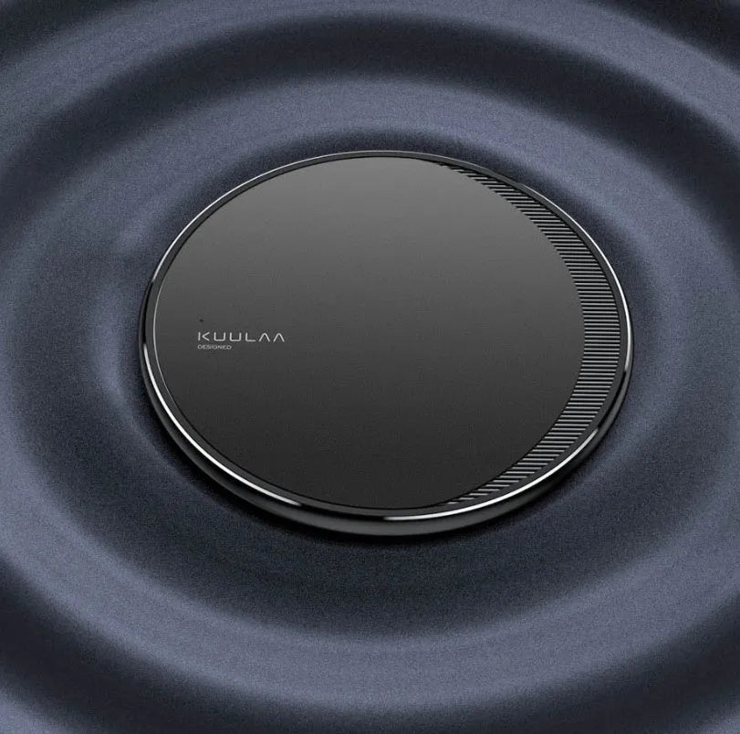 Black Kuulaa KL-CD16 wireless disc phone charger on a surface with LED light on.