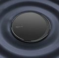 Black Kuulaa KL-CD16 wireless disc phone charger on a surface with LED light on.