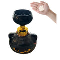 Black plastic cartoon cat shaped foam soap dispenser on a bathroom countertop.