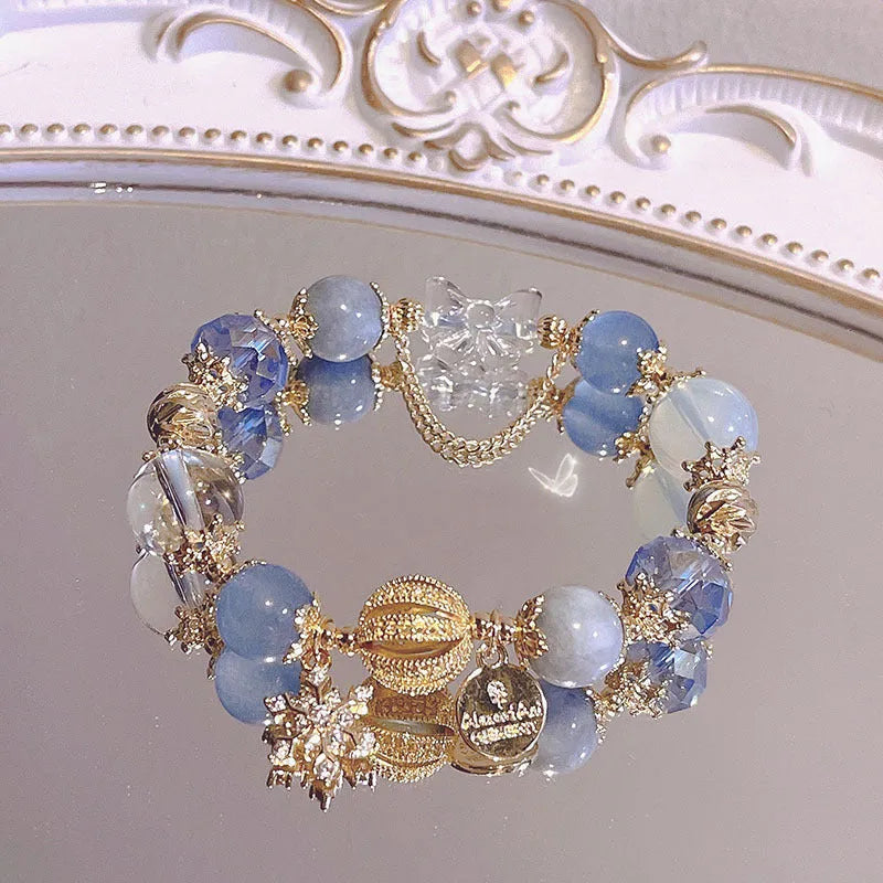 Women's bracelet with snowflake pendant and bow charm in galaxy colours on alloy construction