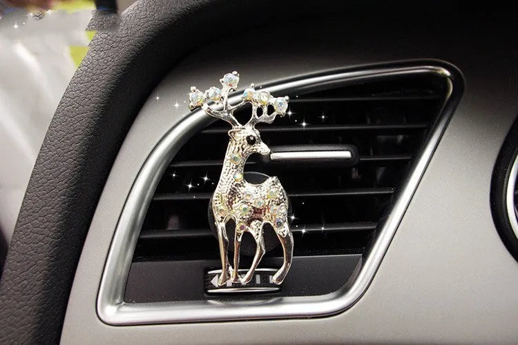 Alloy car fragrance clip with decorative charm attached to car air vent