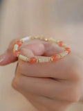 Women's Hetian jade bamboo joint bracelet in 6mm size, shown in jade and South red colours.