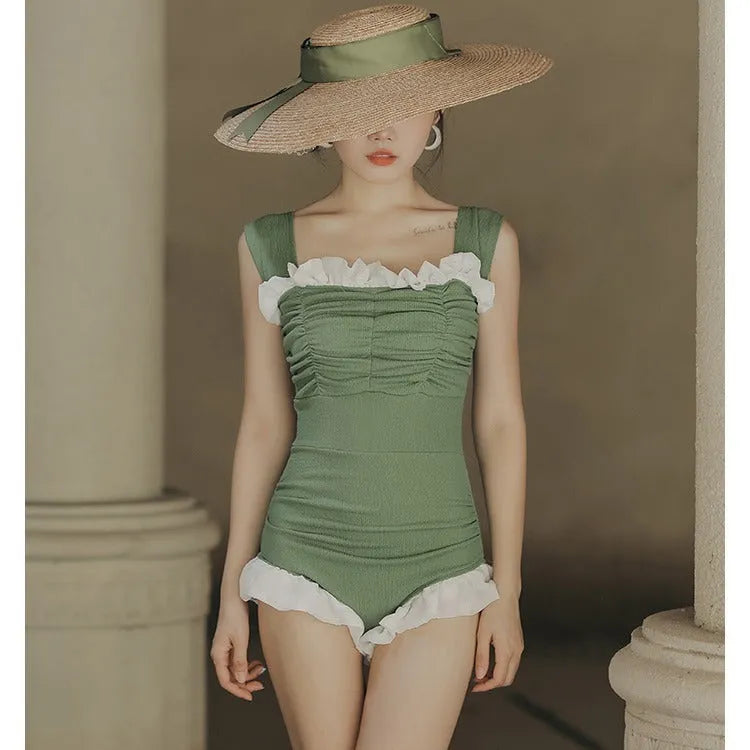 Black high-waisted one-piece swimsuit on a mannequin, showing quick-dry fabric and slimming cut.