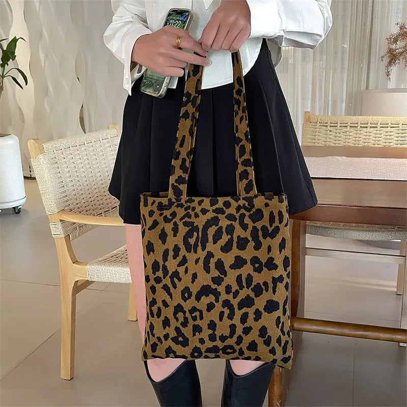 Corduroy leopard print shoulder bag in vertical square shape with open pocket, phone pocket, and document pocket.