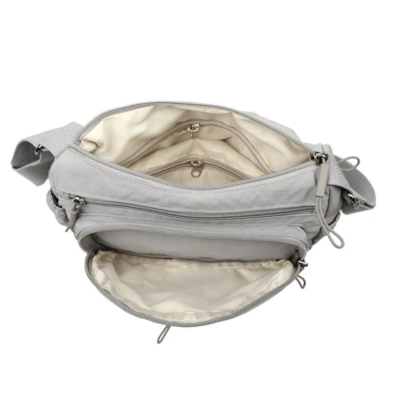 Water-repellent nylon crossbody bag with three-dimensional pocket in black, grey or red