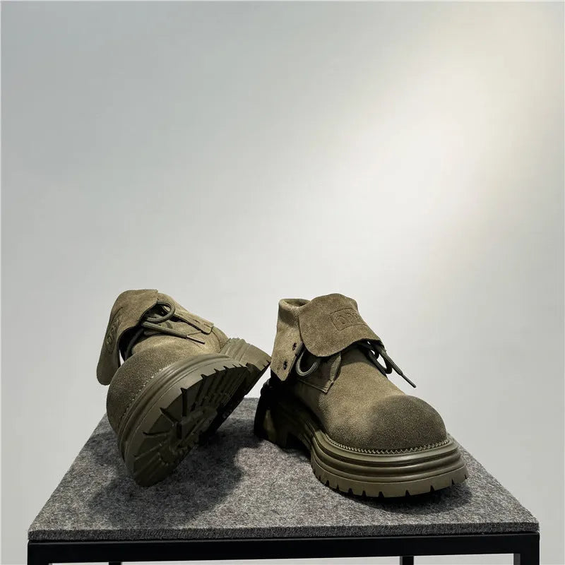 Retro distressed worker boots in cow suede with thick soles and low tube design.