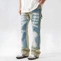 Retro yellow and blue patchwork jeans with splash-ink damaged design on denim fabric