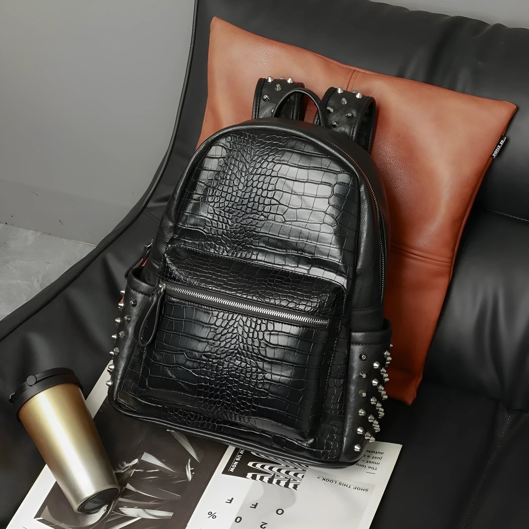 Black waterproof computer schoolbag with oil wax leather features and rivet detailing