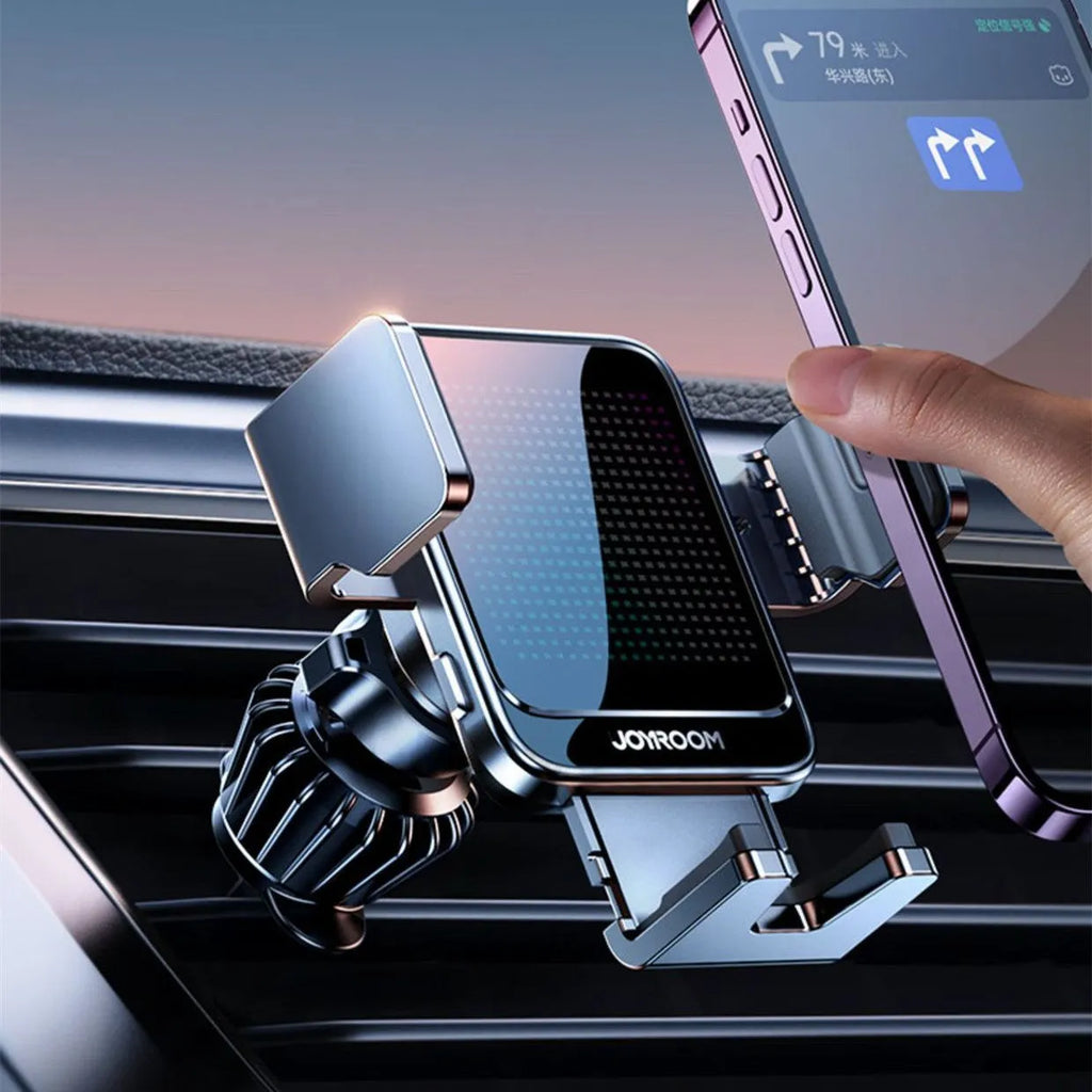 Black automatic wireless car charging bracket mounted on a car air vent, showing a phone placed on the charger.