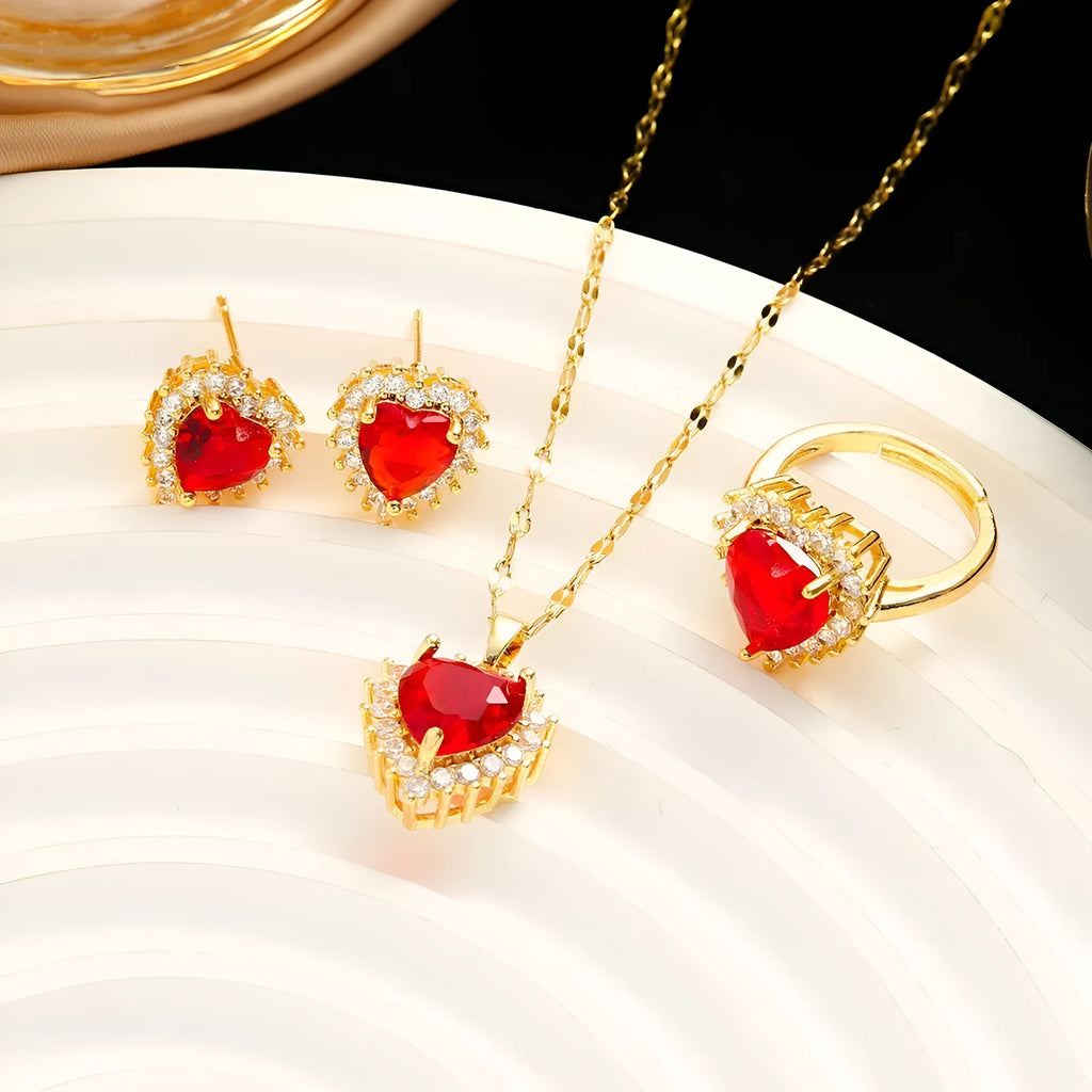 Gold red titanium steel necklace, ear studs, and ring set with hearts and flower pendant designs on a water wave chain.