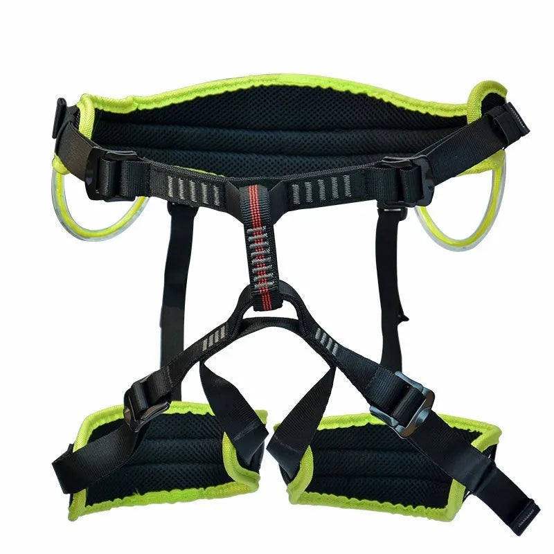 Orange half seat belt climbing safety belt with adjustable waist and leg straps on outdoor rock background