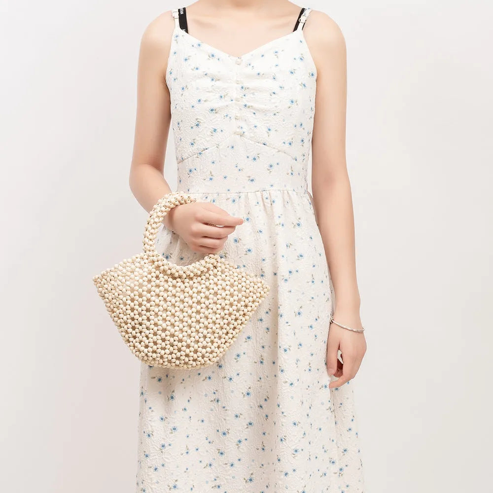 Hand-woven maple beach bag with wooden bead decoration showing hollow dumpling design