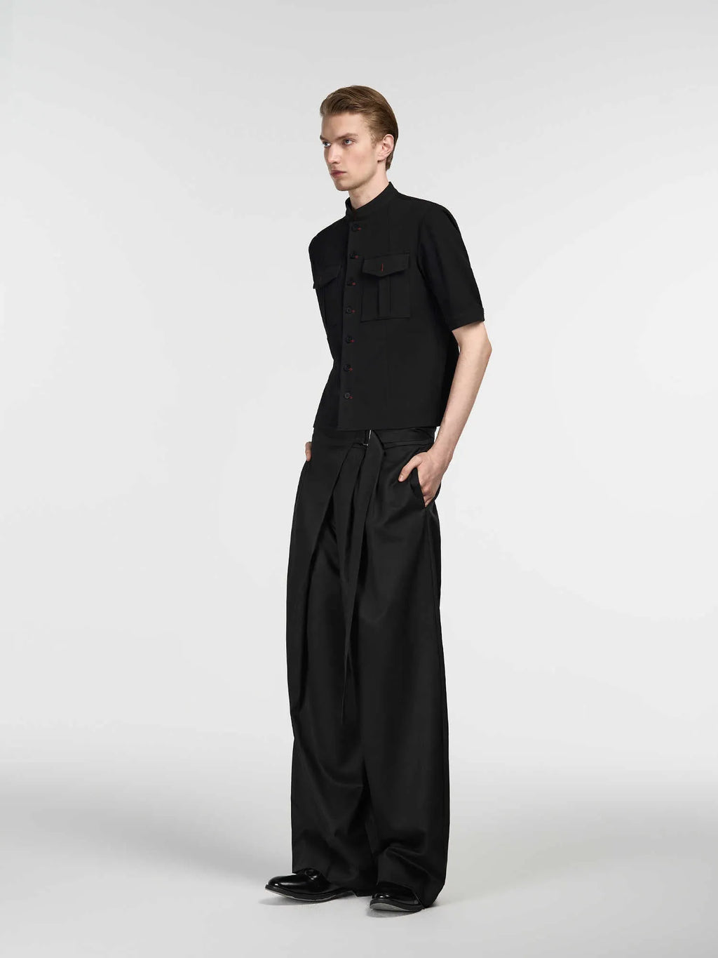 Black straight-leg trousers with adjustable waistband and single-pleat front detail