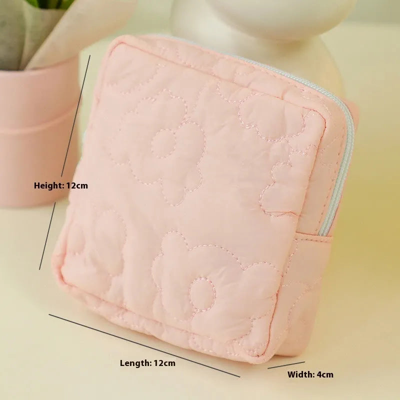 Quilted silk cosmetic storage bag in candy pink, yellow, blue, white, and green colours showing medium and large sizes.