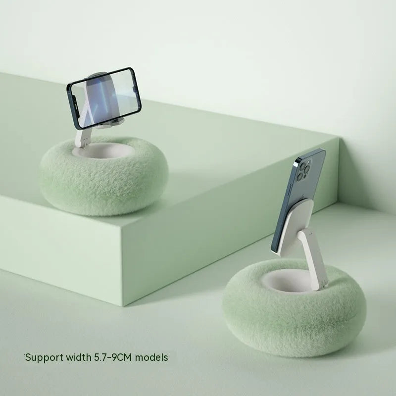 Adjustable rotating bracket holding a tablet, showing vertical extension rod and fabric-covered base.
