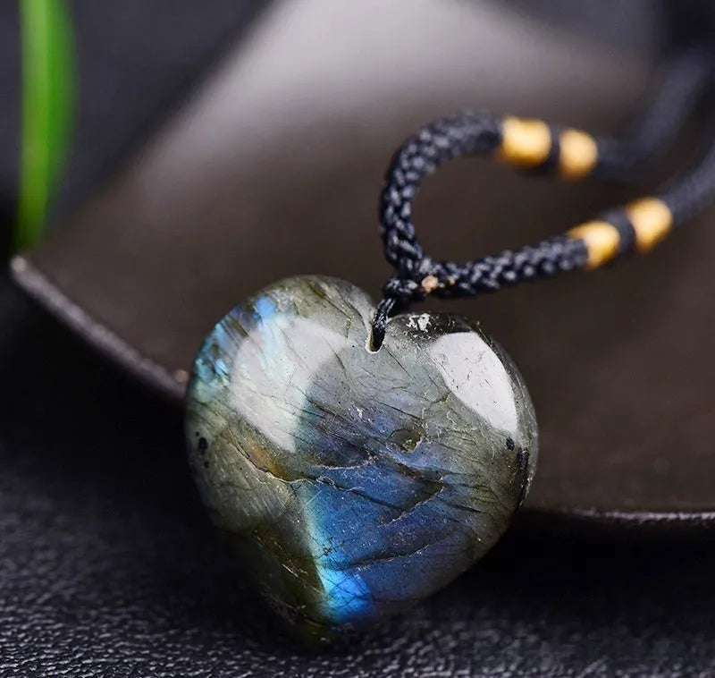 Blue light natural crystal heart pendant necklace on a silver chain, showing size options.