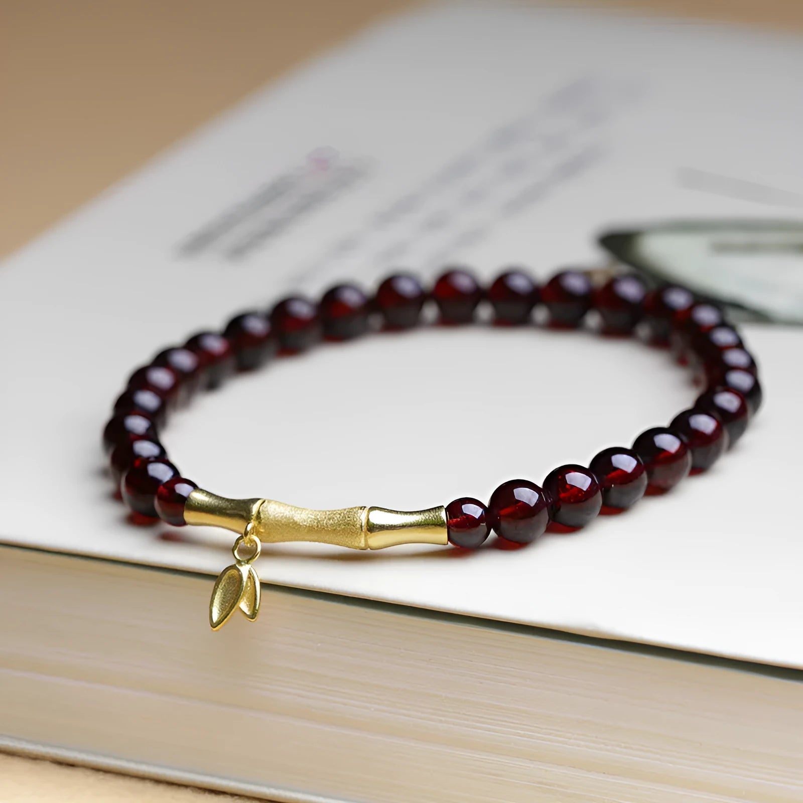 Natural garnet stone set in a 6mm bamboo joint ring bracelet with copper or silver finish.