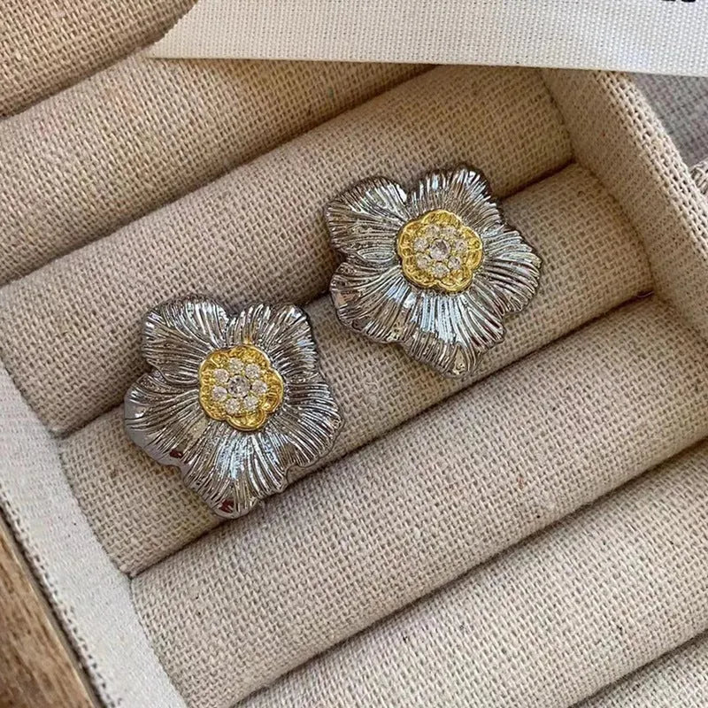 Copper stud earrings with textured gardenia flower design and two-tone electroplated finish.