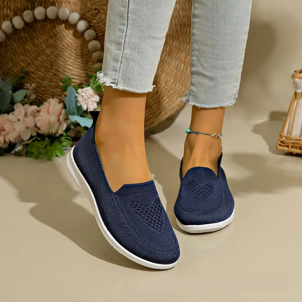 Plus size women's low-top leisure cloth shoes in beige with a heart-shaped pattern and flat sole.