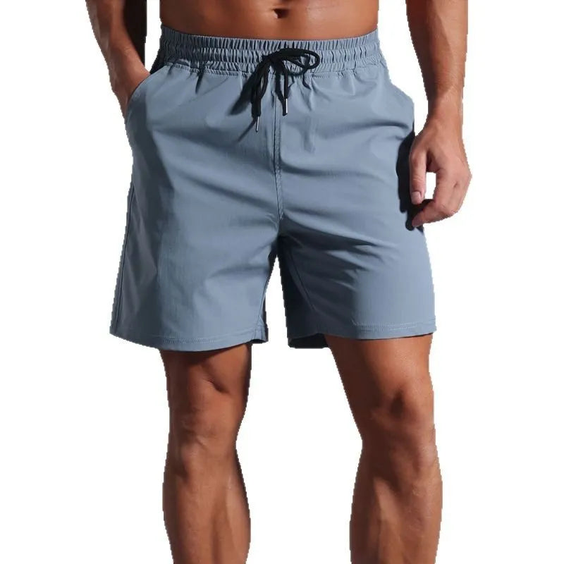 Man wearing loose-fitting khaki casual shorts made from quick-dry polyester fabric.
