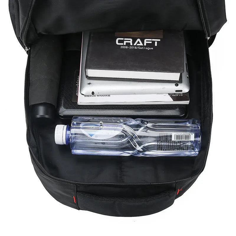 Large nylon backpack in black with curved shoulder straps and letter detailing, showing front compartment