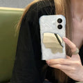 Water ripple solid colour mirror iPhone case in beige, shown on an iPhone