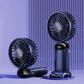 Blue portable USB rechargeable fan shown in handheld mode, with folding neck strap and digital battery display