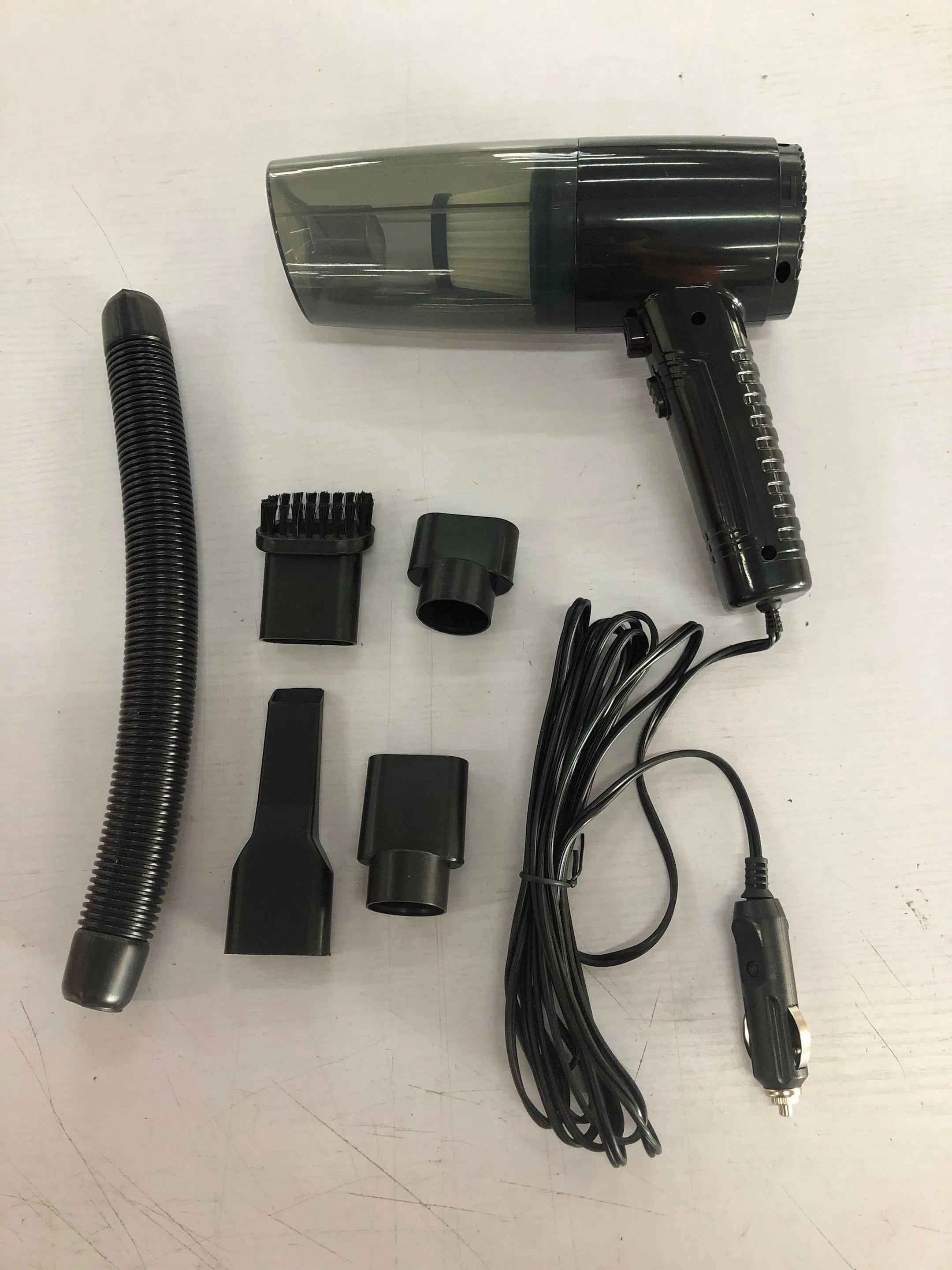 Starry Sky Black handheld car vacuum cleaner with attachments on a car seat.