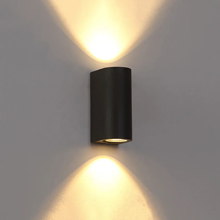 Modern aluminium LED wall lamp in a black finish mounted on a wall.
