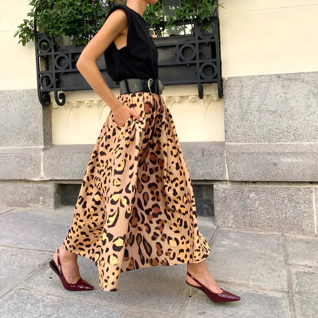 Brown leopard print women's A-line long skirt with a large hem, shown on a hanger.