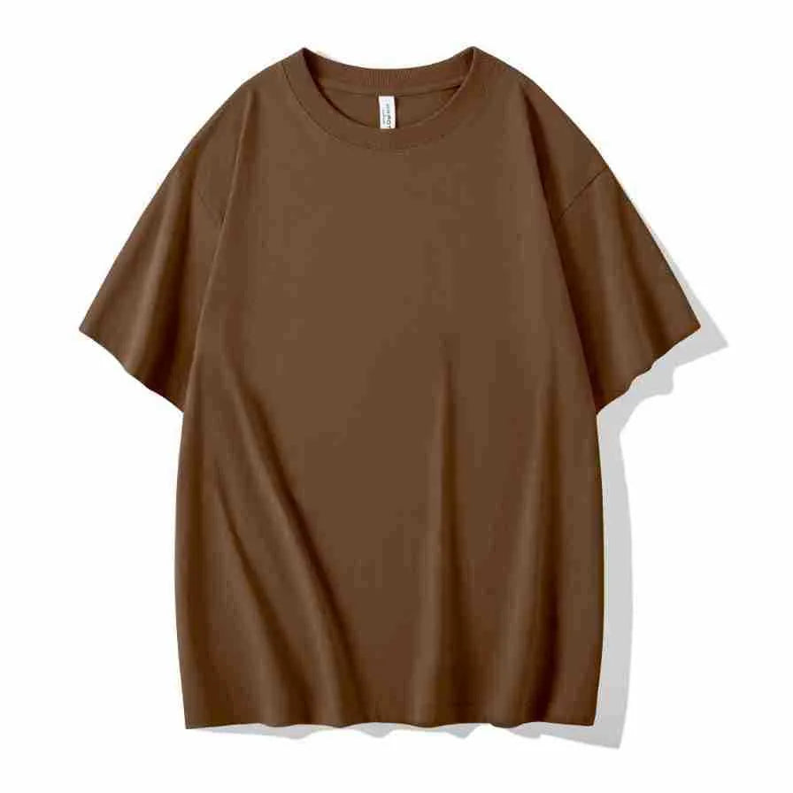 Man wearing a heavyweight apricot coloured drop shoulder loose fit t-shirt for casual wear.
