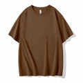 Man wearing a heavyweight apricot coloured drop shoulder loose fit t-shirt for casual wear.