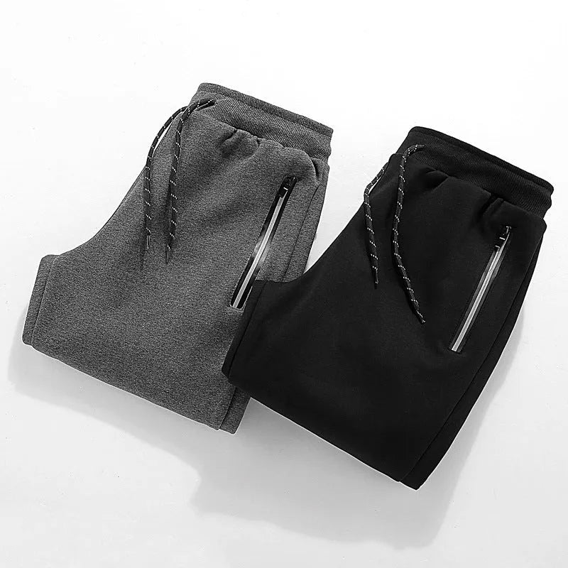 Men's sports casual harem pants in black, side view, with elastic waist and relaxed fit.