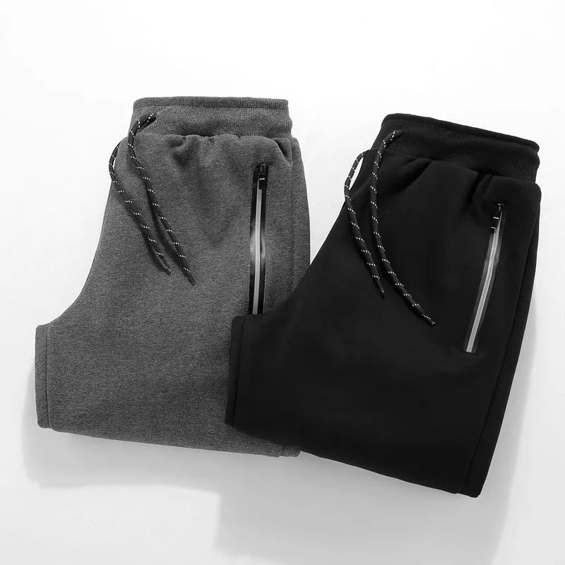 Men's sports casual harem pants in black, side view, with elastic waist and relaxed fit.