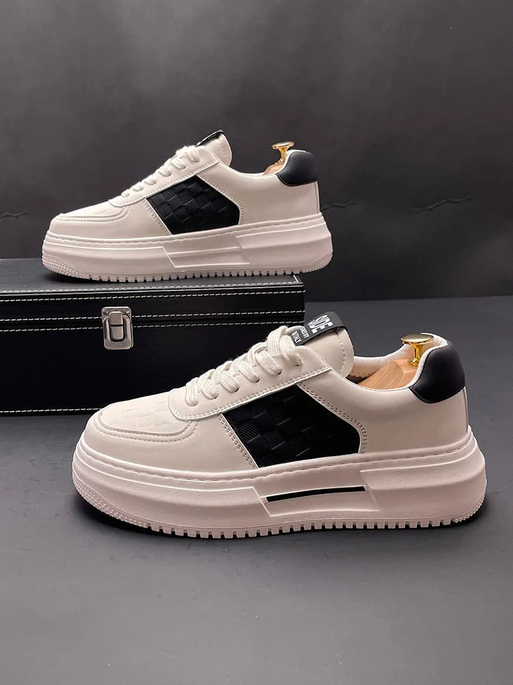 A pair of white, green, and black sports-style casual shoes with a cloth upper and rubber foam sole.