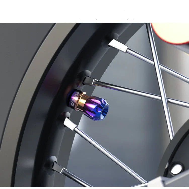 Pair of motorcycle tyre valve core caps in T6 aluminium alloy and 304 stainless steel, CNC machined, with oxidation colouring.