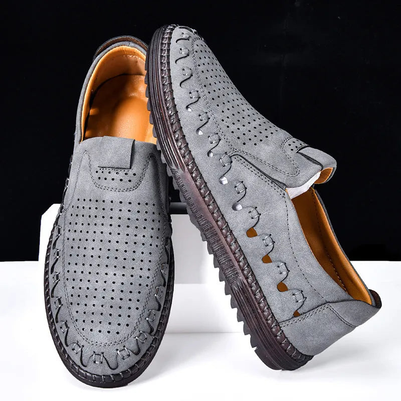 Men's brown casual slip-on shoes with round toe, low top, and sleeve entry design on a plain background.