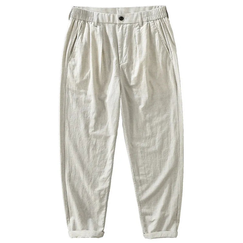 Man wearing loose fit brown cotton linen straight-leg trousers with a casual top.