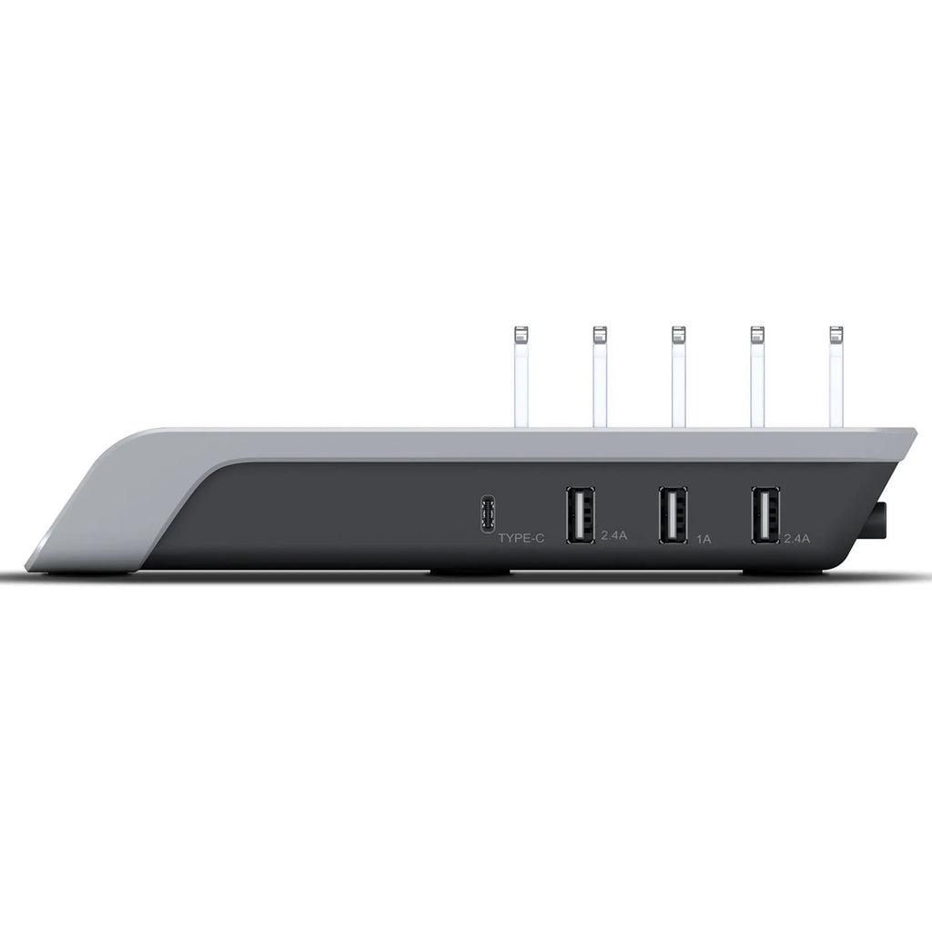 Black universal mobile phone and tablet charging stand on a desk.