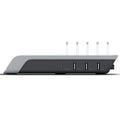 Black universal mobile phone and tablet charging stand on a desk.