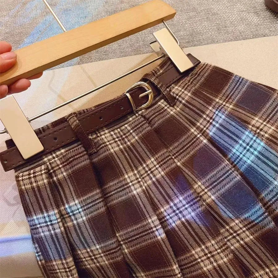 Girls' red and black plaid pleated A-line skirt with a cotton blend fabric.