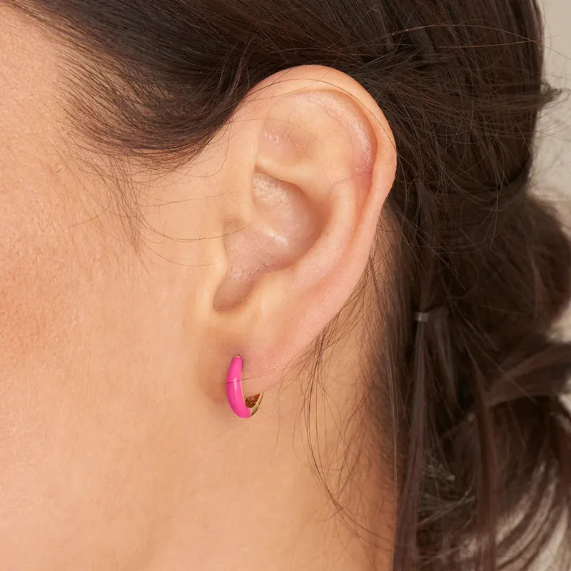A pair of curved oval epoxy earrings on a U-shaped silver-plated copper base.