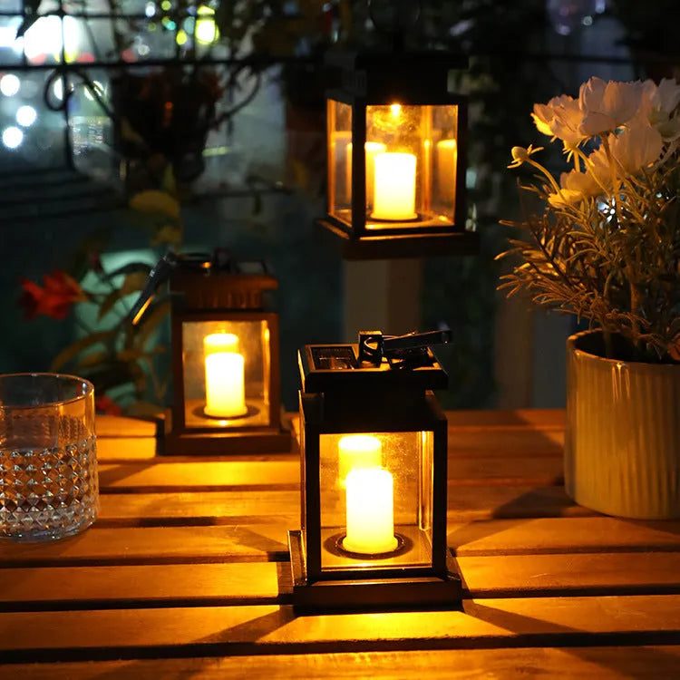 Black solar wind lamp with warm white LED light on outdoor table