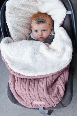 Envelope-style baby stroller sleeping bag in a plain colour, shown on a pram with lamb cashmere lining visible.